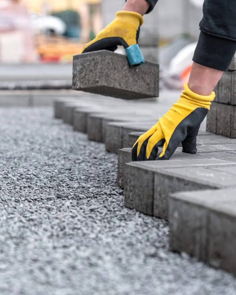 laying interlocking pavers during the construction of sidewalks and roads.